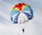 Парашютиста вниз сквозь облака на парашюте после прыжка с самолета